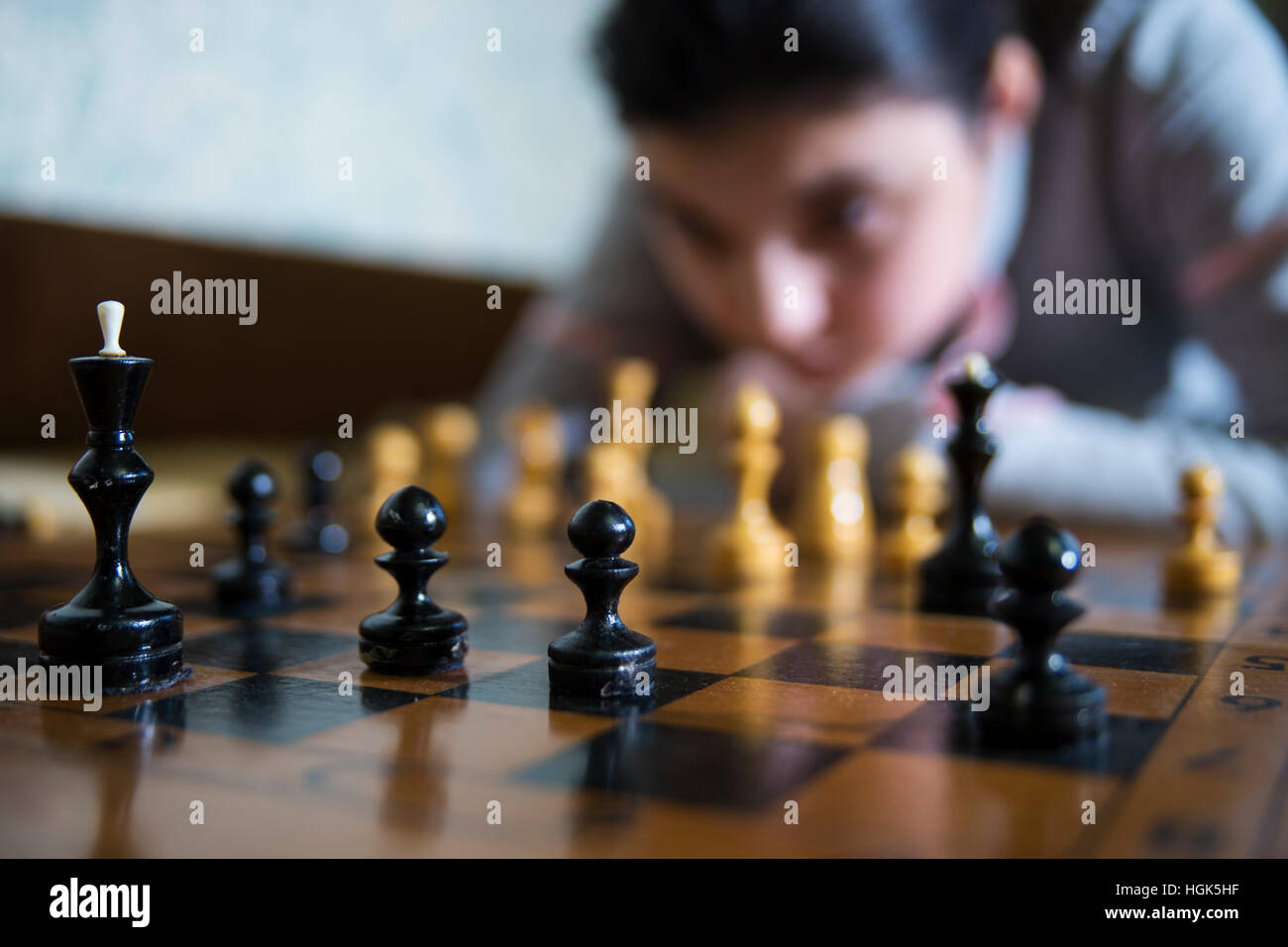 teen girl making checkmate playing chess, she is winner Stock Photo