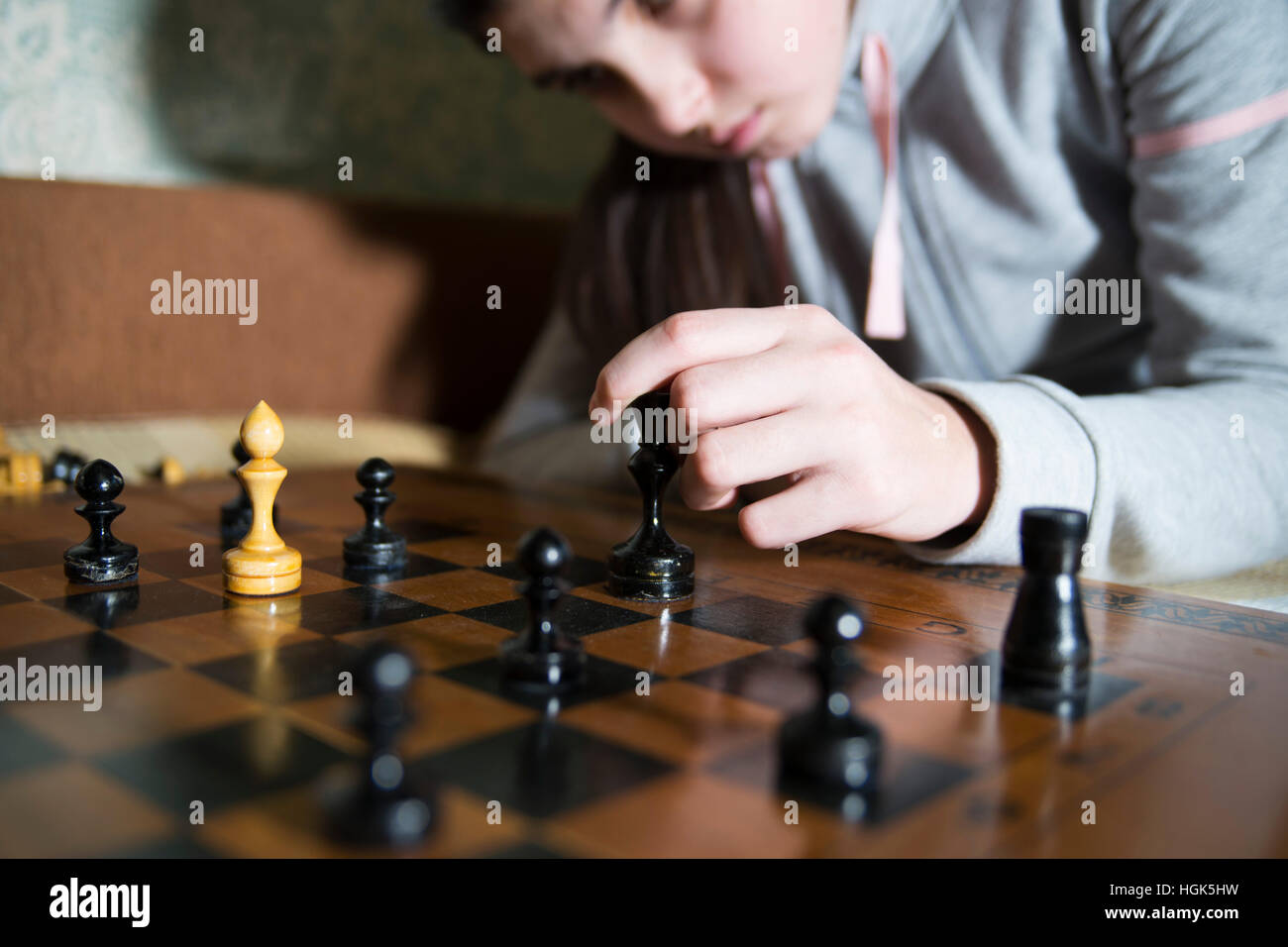 teen girl making checkmate playing chess, she is winner Stock Photo