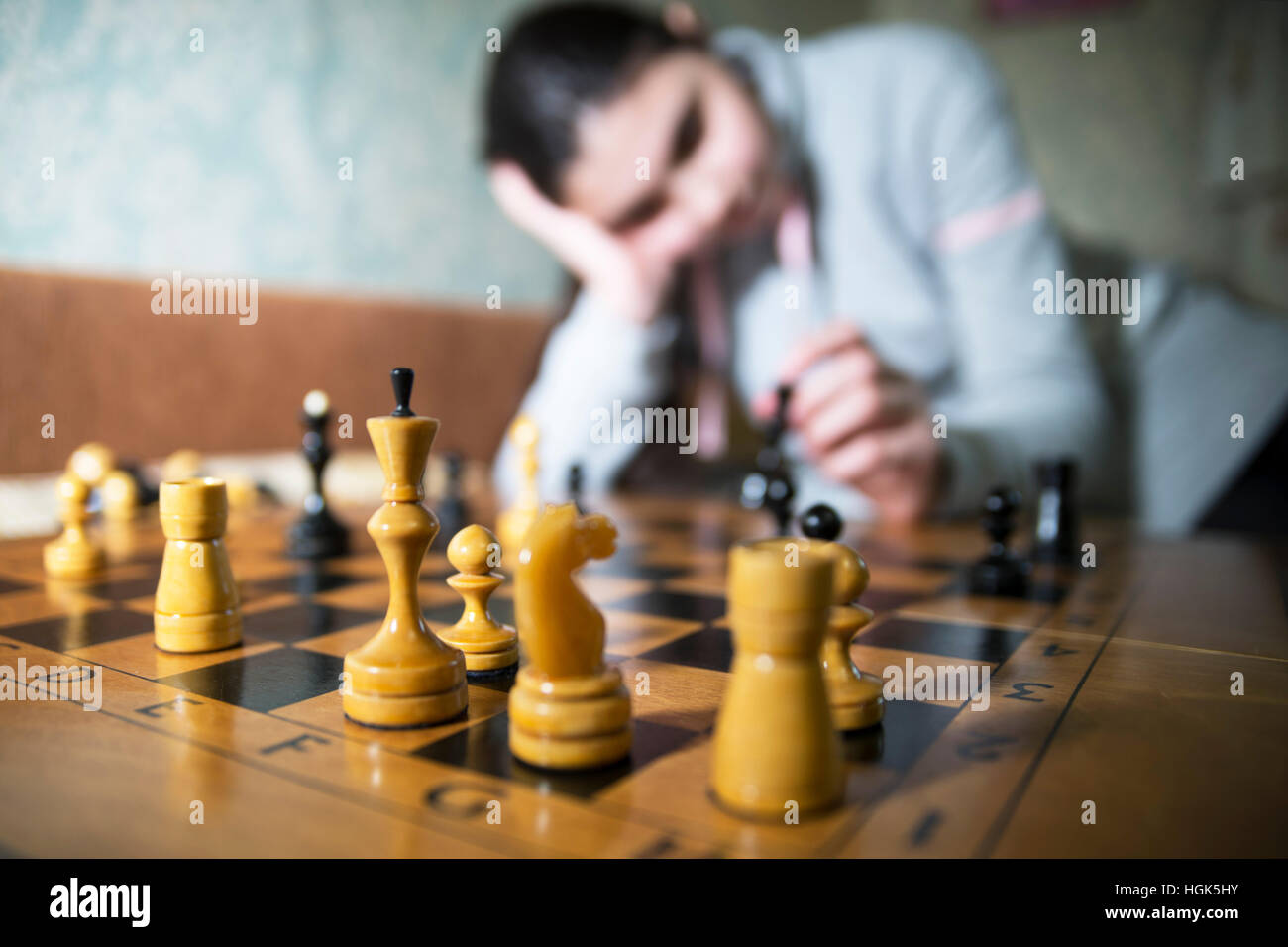 teen girl making checkmate playing chess, she is winner Stock Photo