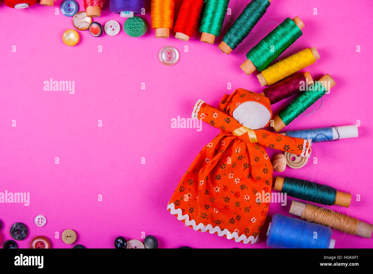 Toy with colorful thread and pink background Stock Photo - Alamy
