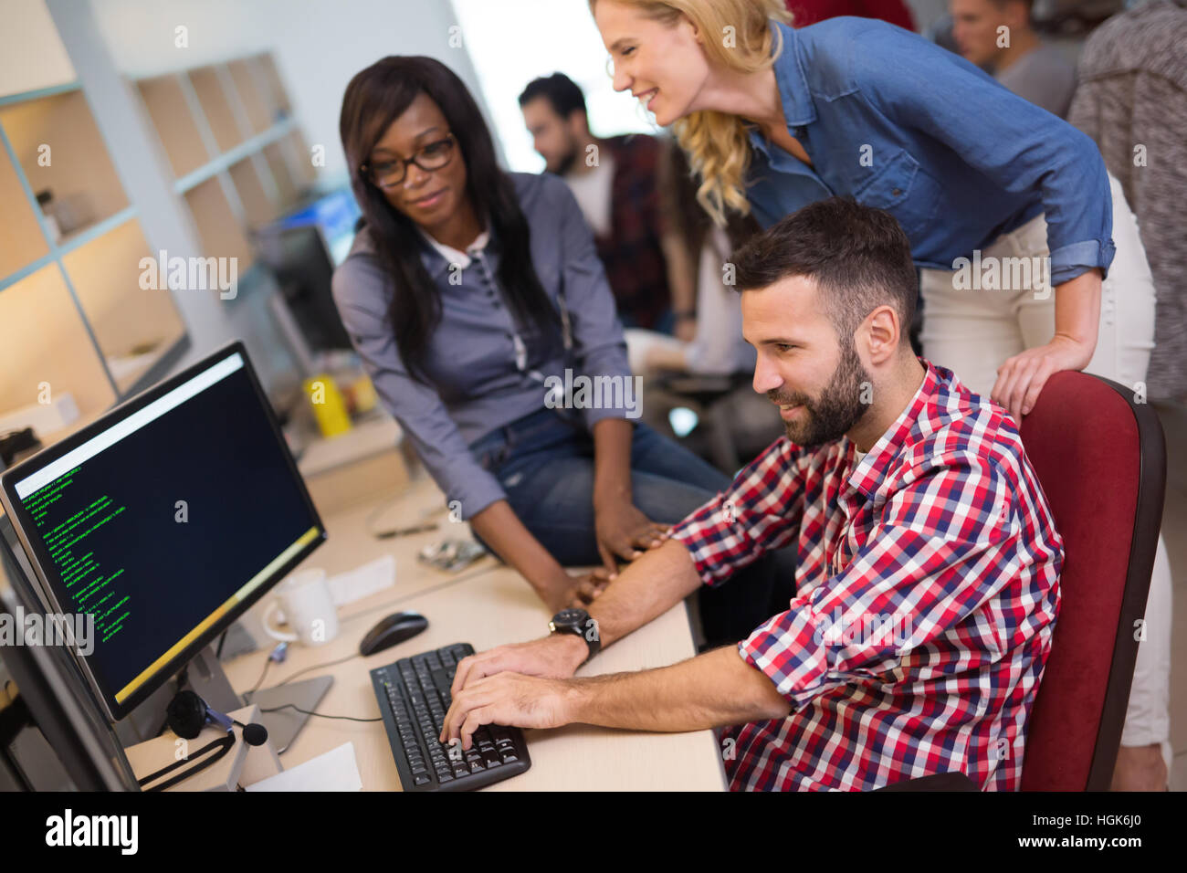 Coworkers working on project together in company office Stock Photo