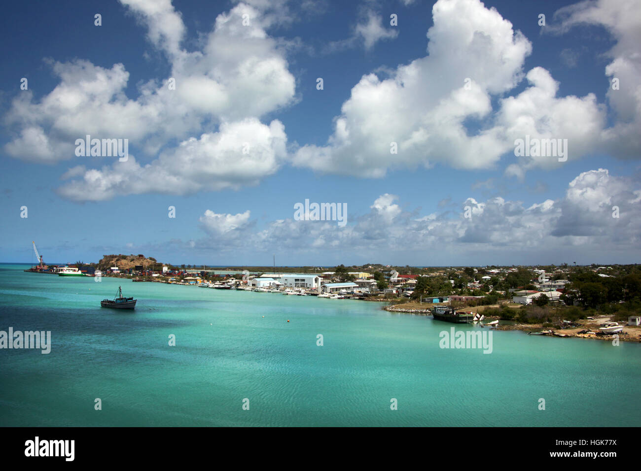 Blue sky & turquoise water. Cruising out of the port of St John's, Antigua on a beautiful day, Caribbean. Stock Photo