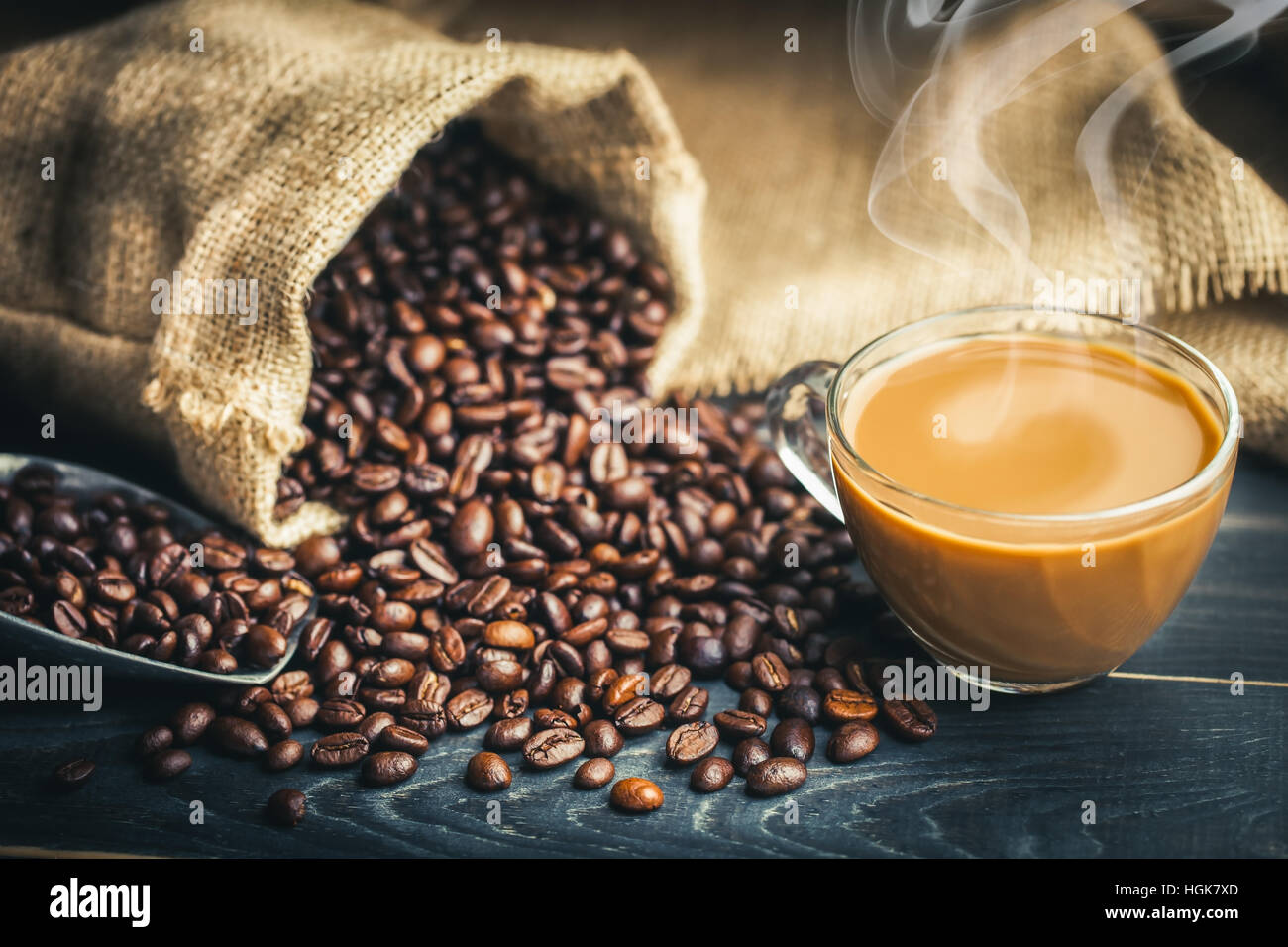 Coffee cup and coffee beans with bag, scoop and smoke - classic concept. Stock Photo