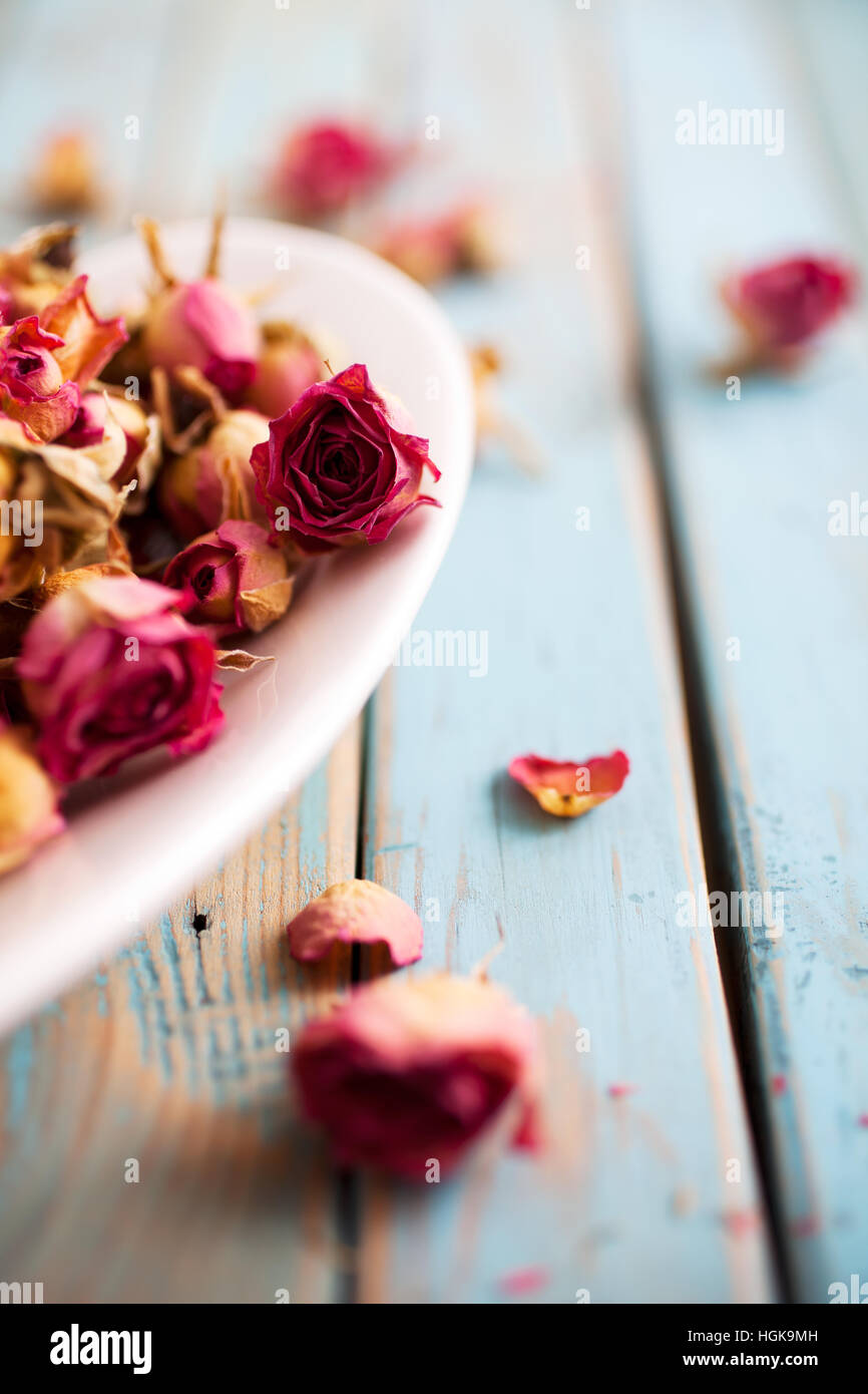 Beautiful dried roses on wooden background Stock Photo