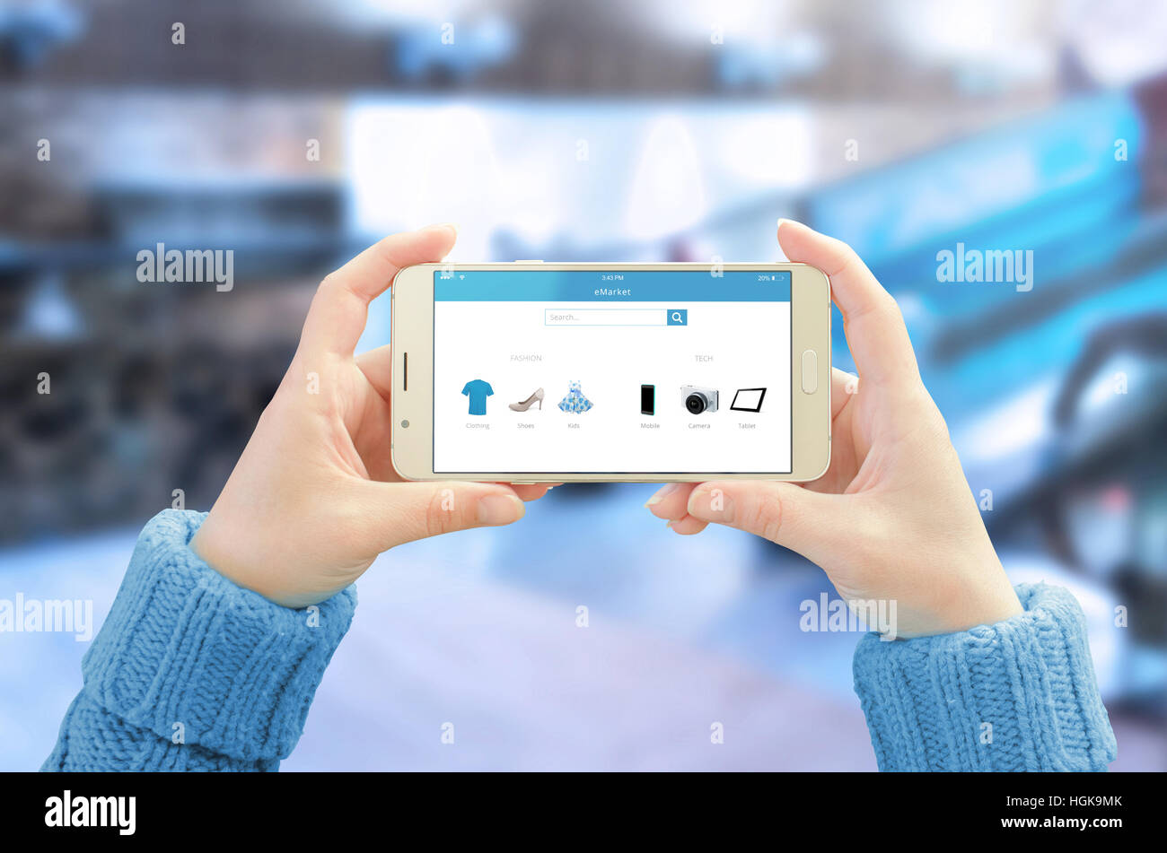 Phone in horizontal position in woman hands. Commerce app with modern user friendly interface on mobile display. Business center in background. Stock Photo