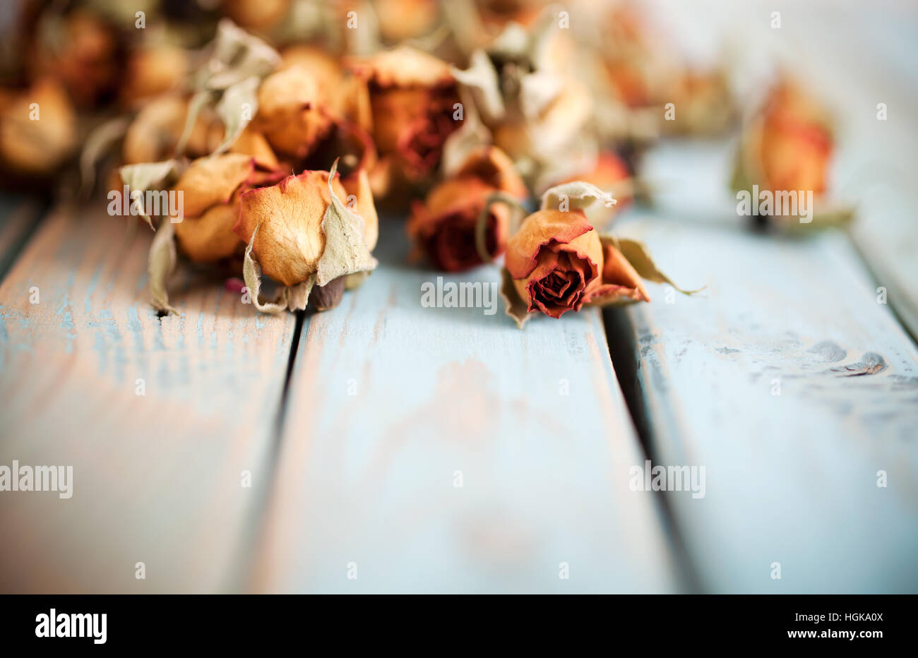 Beautiful dried roses on wooden background Stock Photo - Alamy