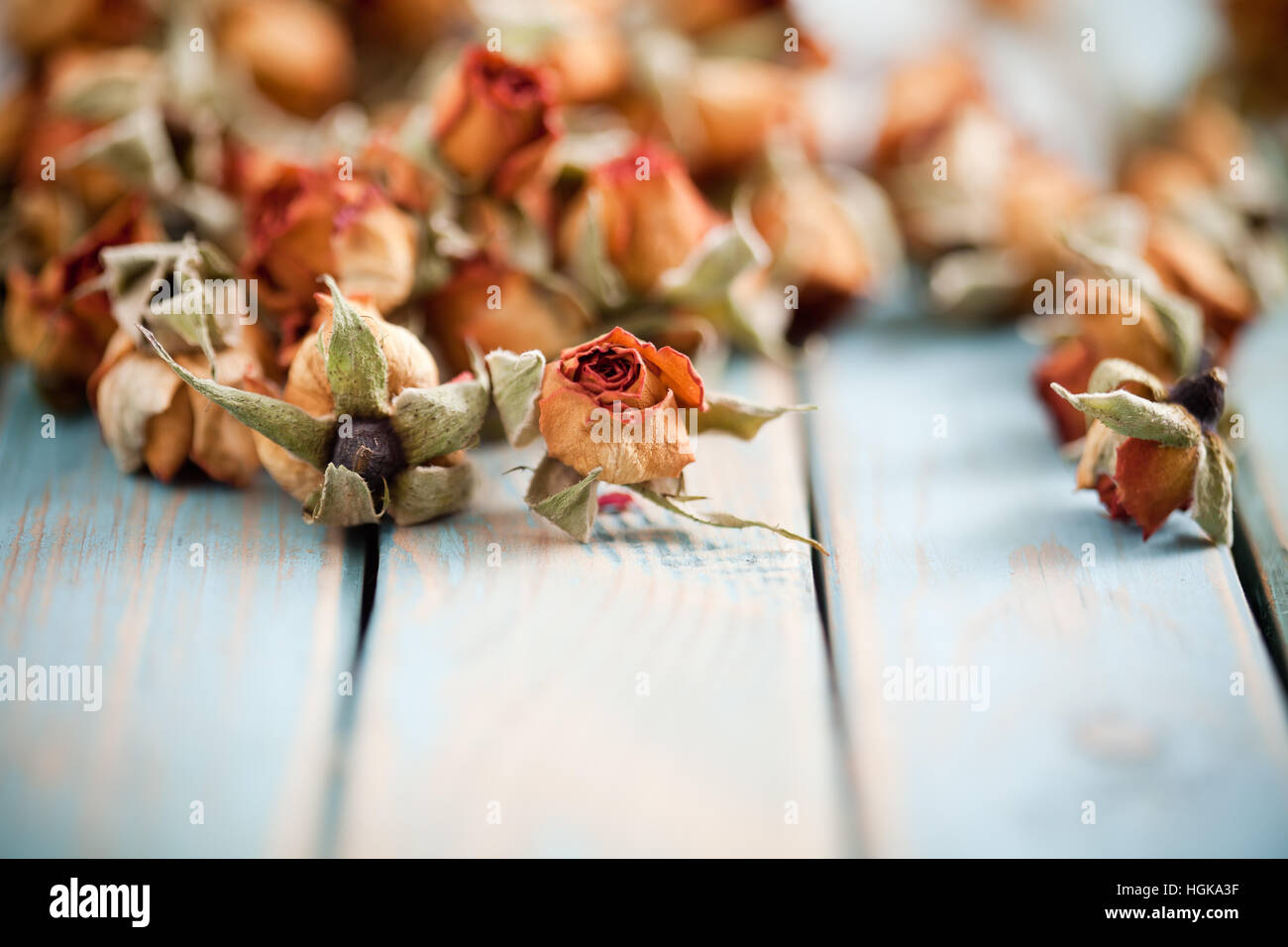 Beautiful dried roses on wooden background Stock Photo - Alamy
