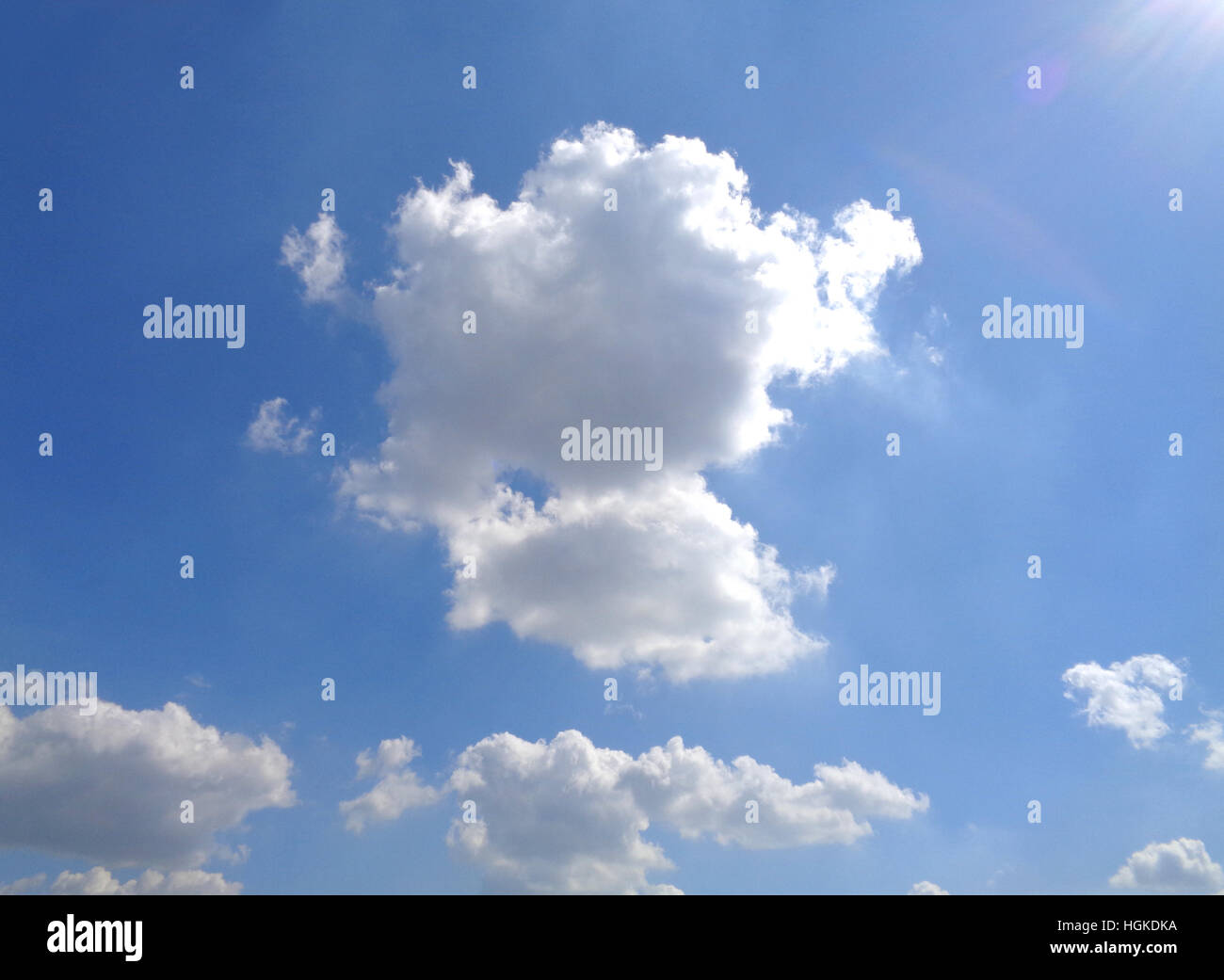 White Fluffy Cloud Floating on Vivid Blue Sunny Sky Stock Photo - Alamy