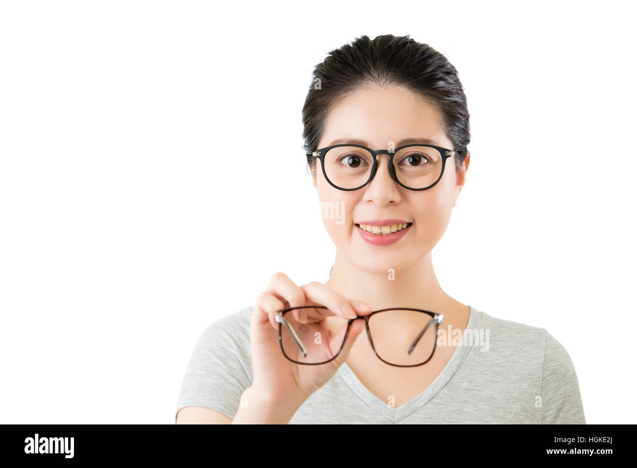 young smilling asian woman hold new vision glasses. isolated on white
