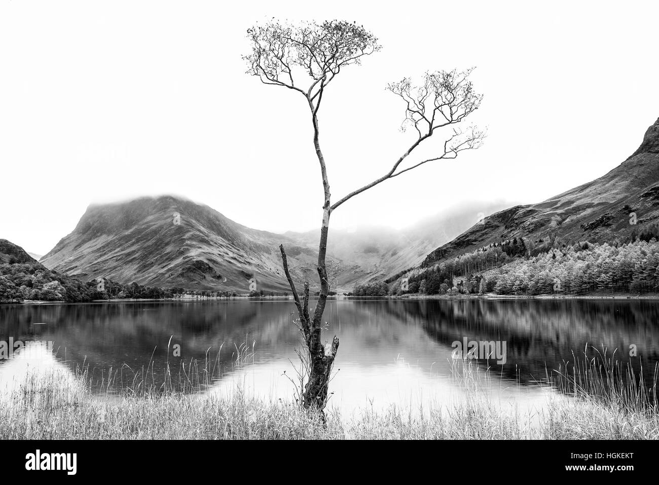 Stunning black and white high key landscape image of Lake Buttermere in Lake District England Stock Photo