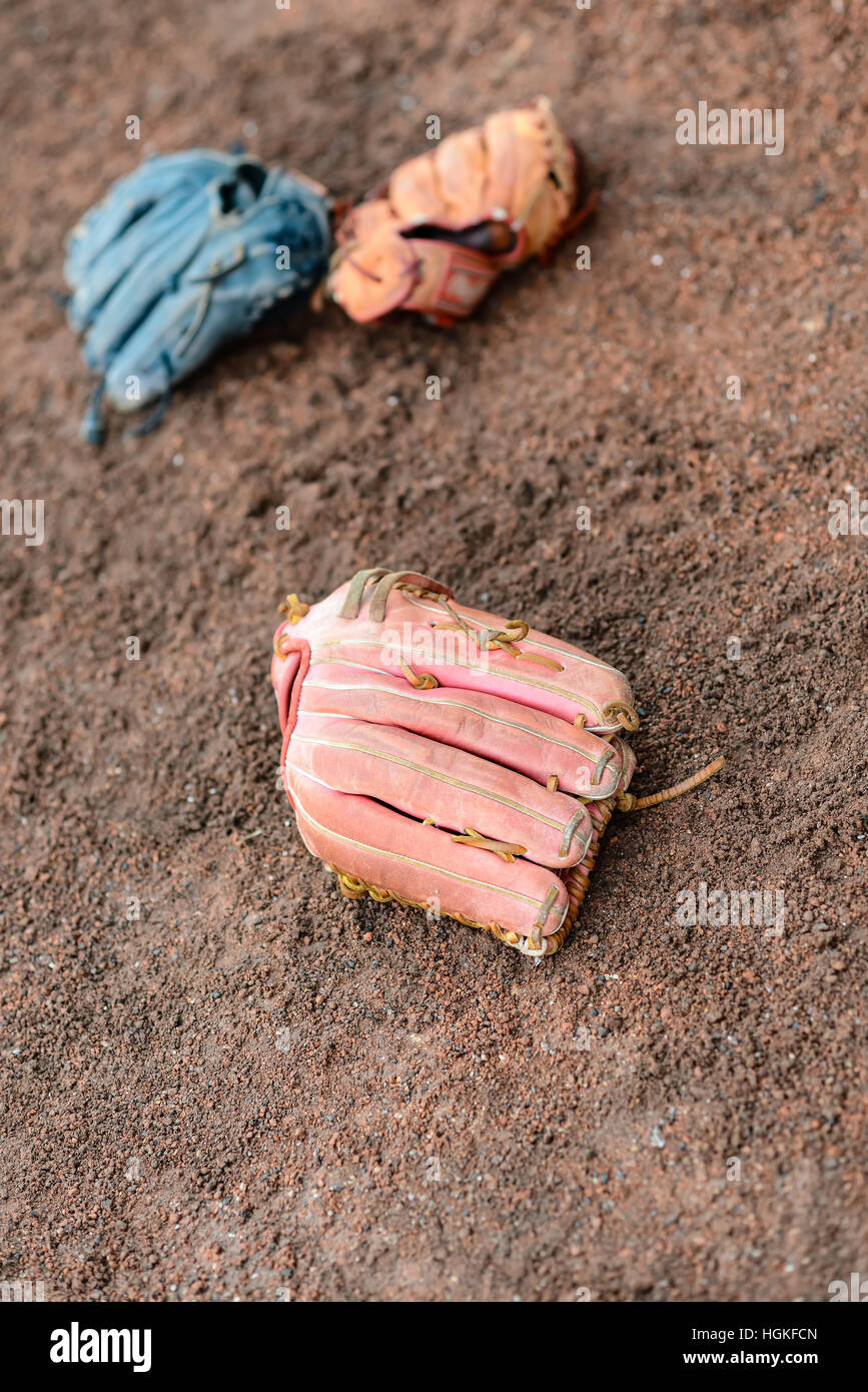 baseball gloves on the ground vertical composition Stock Photo