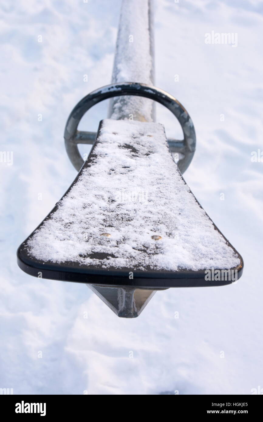 Frozen seesaws covered with snow and ice in the park Stock Photo