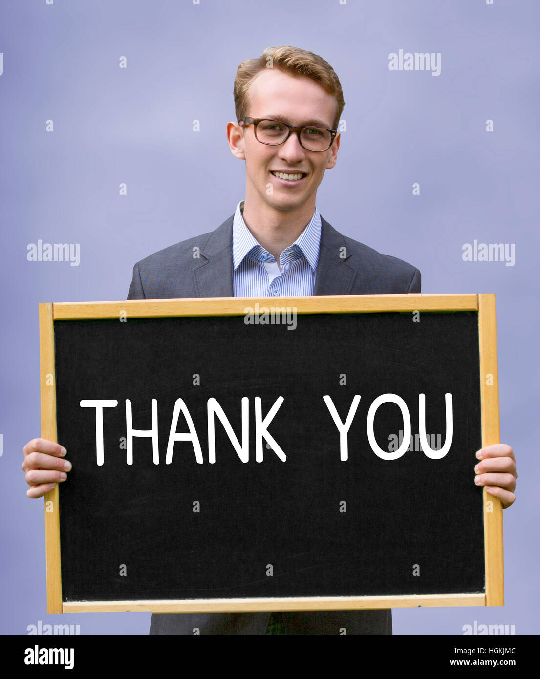 young businessman holding chalkboard with the words Thank You Stock Photo