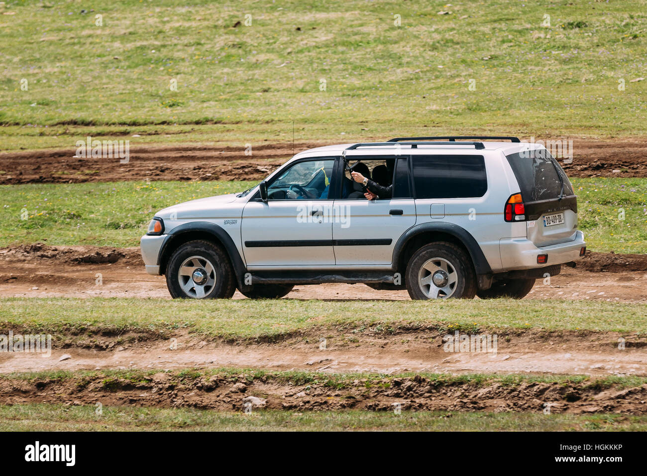 Kazbegi, Gergia - May 23, 2016: Mitsubishi Montero Sport SUV driving on off road in summer meadow. Mitsubishi Pajero Sport is a mid-size SUV produced Stock Photo