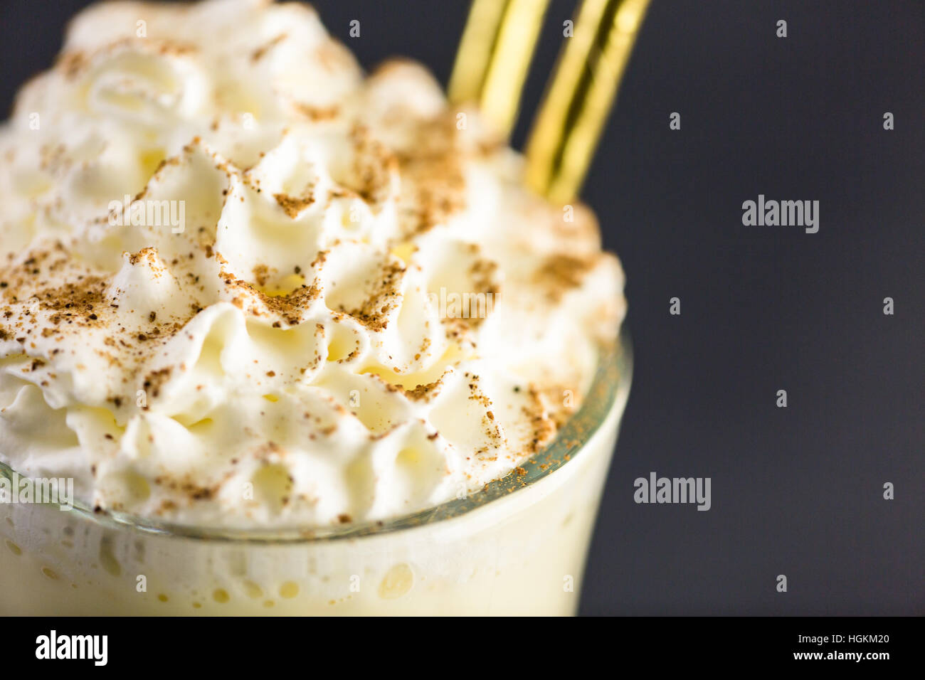 Traditional holiday drink egg nog garnished with whipped cream in the ...