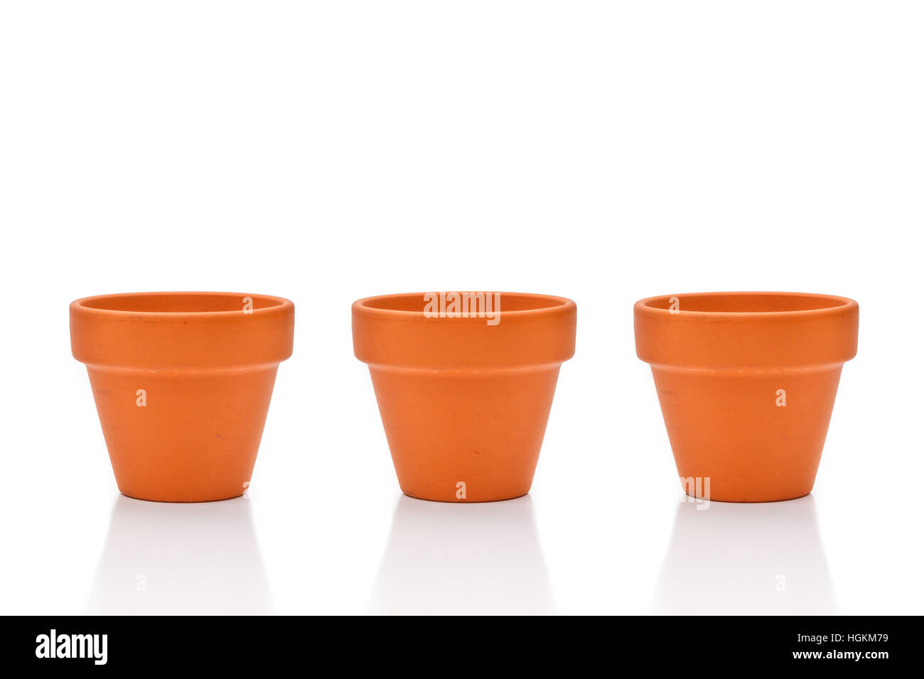 Three terracotta flower pots isolated on white Stock Photo - Alamy