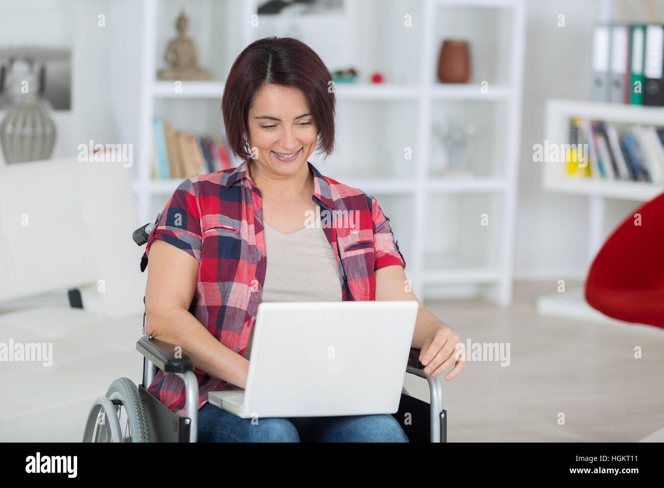 disabled woman on wheelchair with laptop at home Stock Photo - Alamy
