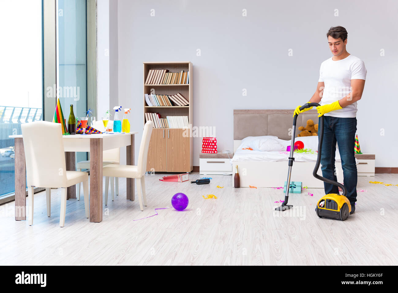 Man cleaning the house after christmas party Stock Photo - Alamy