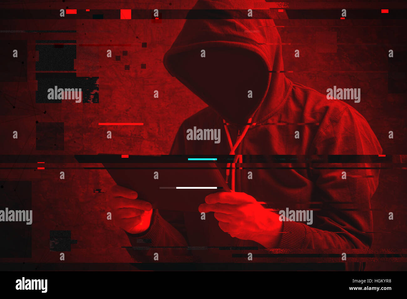 Cyber attack with unrecognizable hooded hacker using tablet computer, digital glitch effect Stock Photo