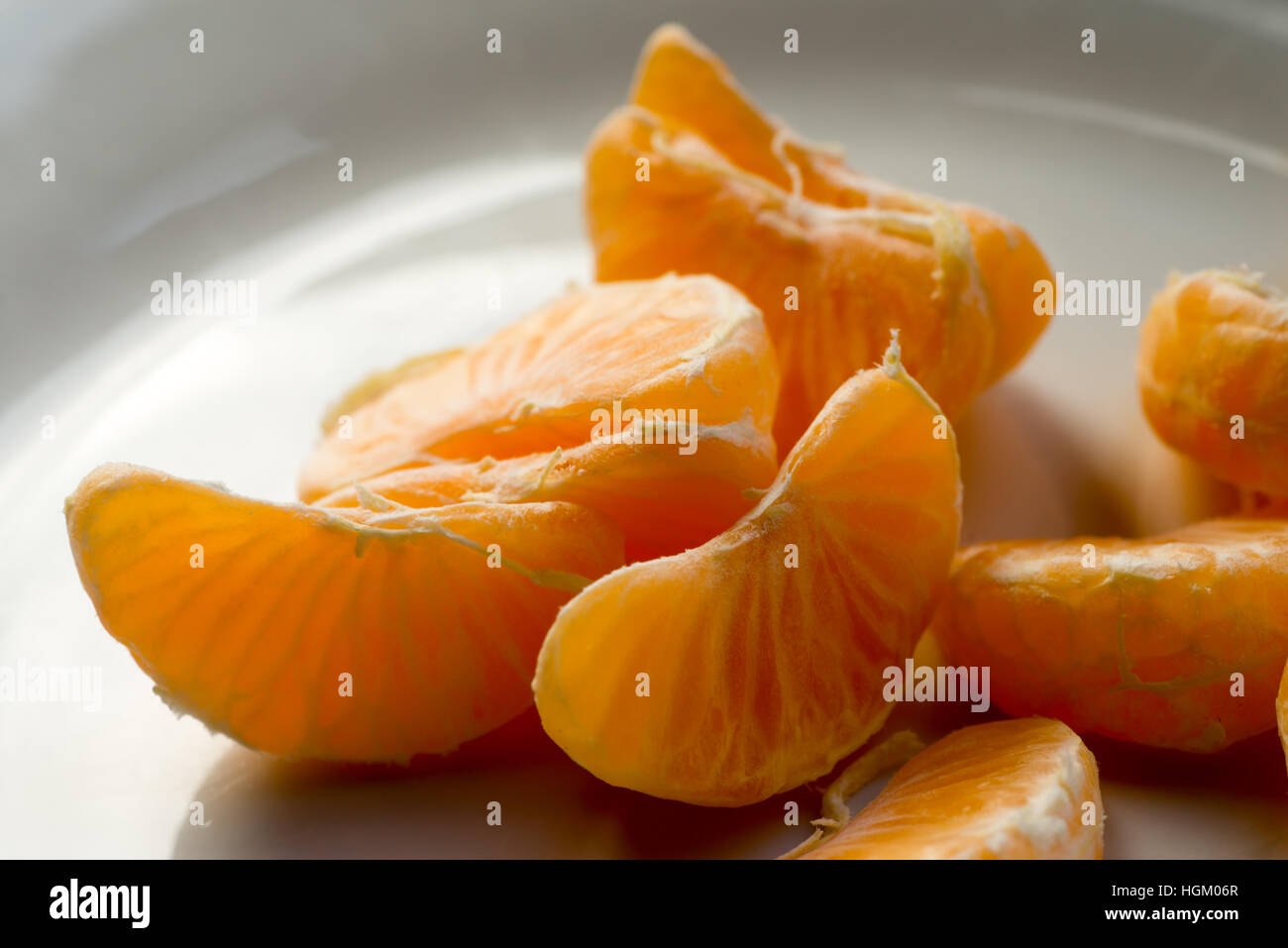 closeup to slices of tangerine on white plate Stock Photo