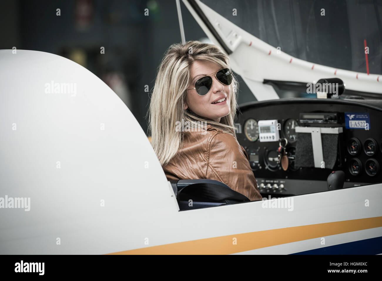 Female pilot inside airplane cockpit Stock Photo