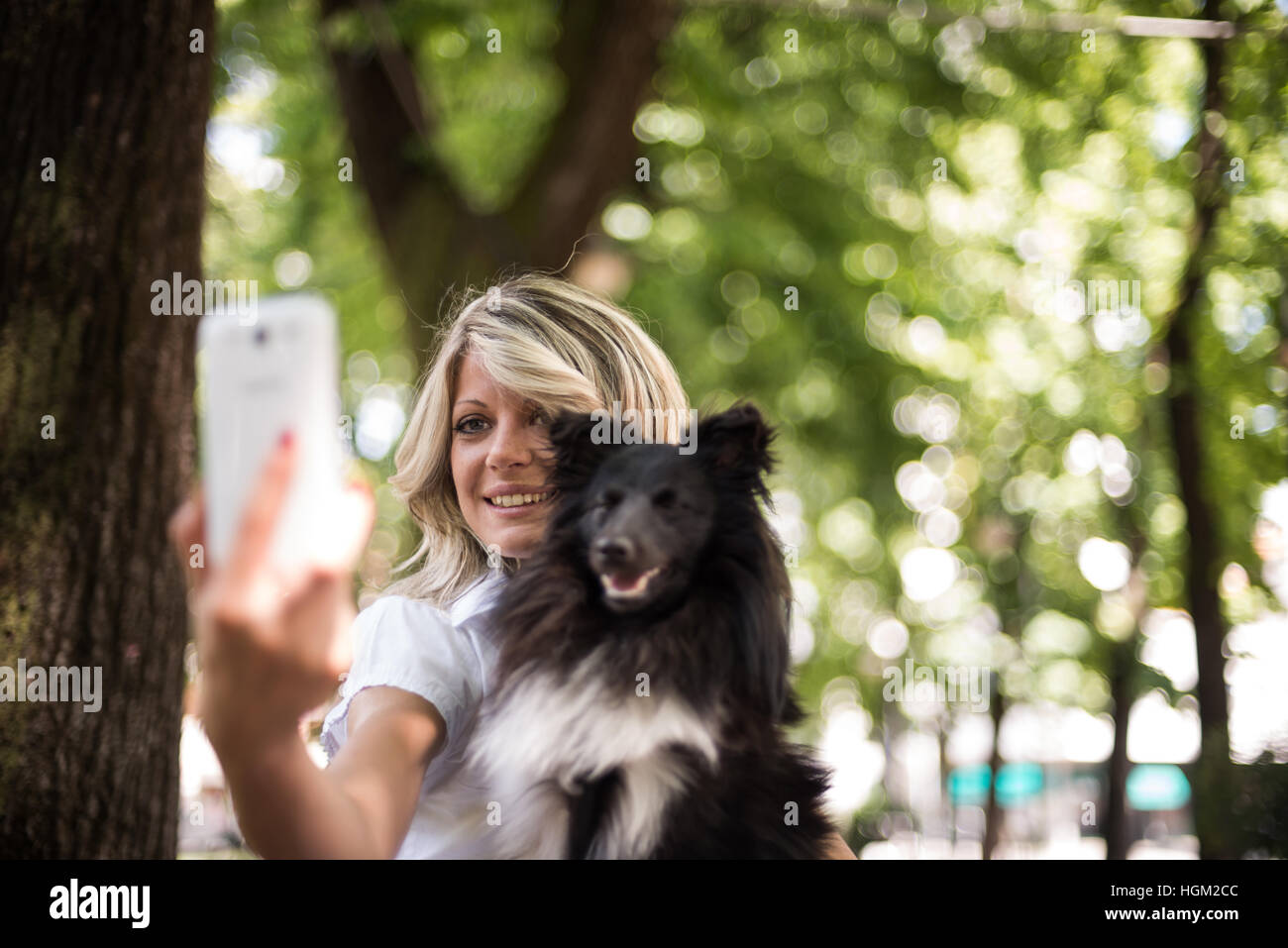Young woman making a selfie with her dog Stock Photo - Alamy