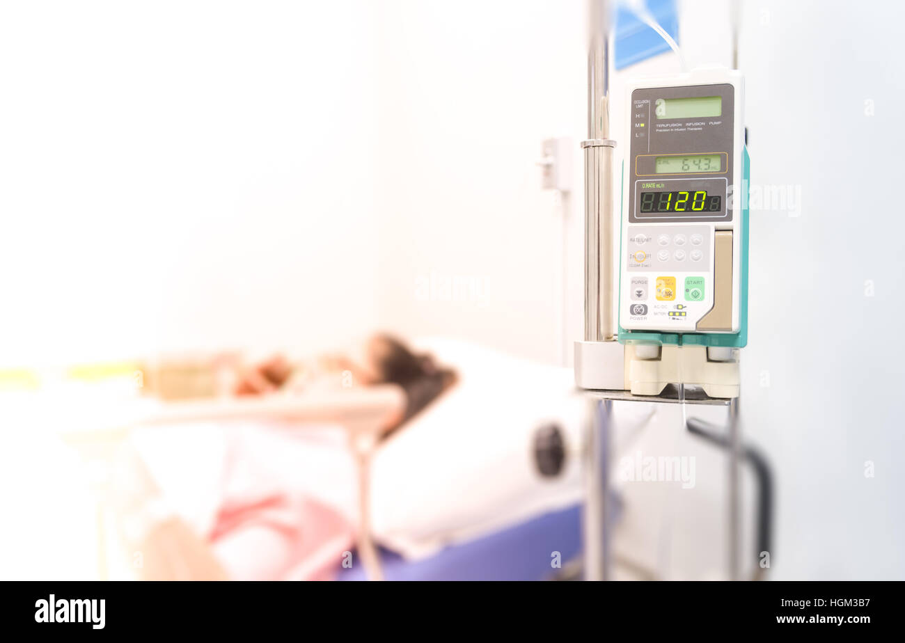 Infusion pump feeding IV drip into patients Stock Photo Alamy