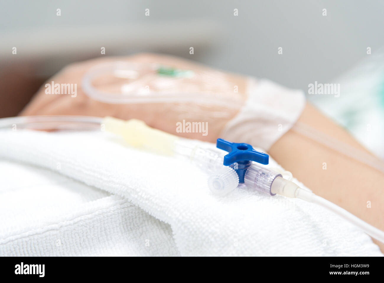 Close-up IV needle on patient  in the hospital Stock Photo