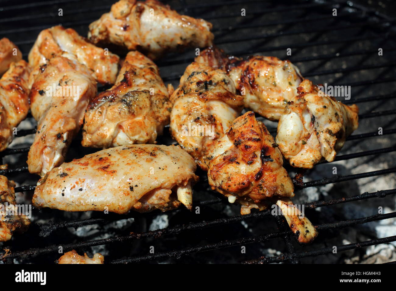 Cooking marinated chicken pieces on a barbecue Stock Photo Alamy