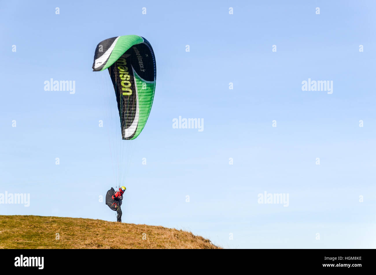 Paraglider taking off from Mont d'Or in France and flying over the Jura mountains Stock Photo