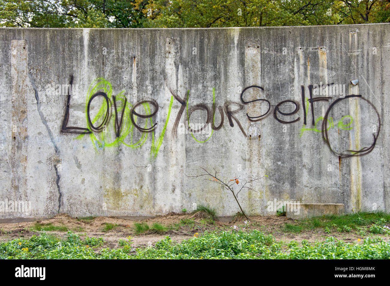 inspirational graffiti on grungy cement city wall Stock Photo