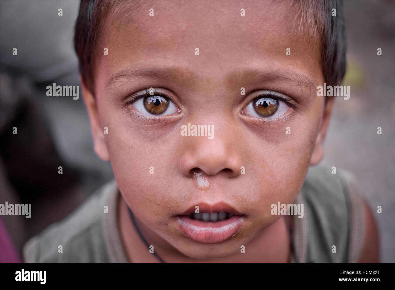 Curiously looking Indian boy with big eyes and sad face.Indian village