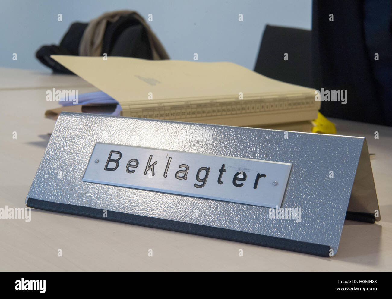 A sign reads "Beklagter" (lit. defendant) on a table before the start of the trial in the courtroom in Munich, Germany, 11 Janaury 2017. An estate agent is demanding 300,000 euros from professional footballer J. Boateng, who is accused of not having paid the agent's fee for his house in Gruenwald near Munich, Germany. Photo: Peter Kneffel/dpa Stock Photo