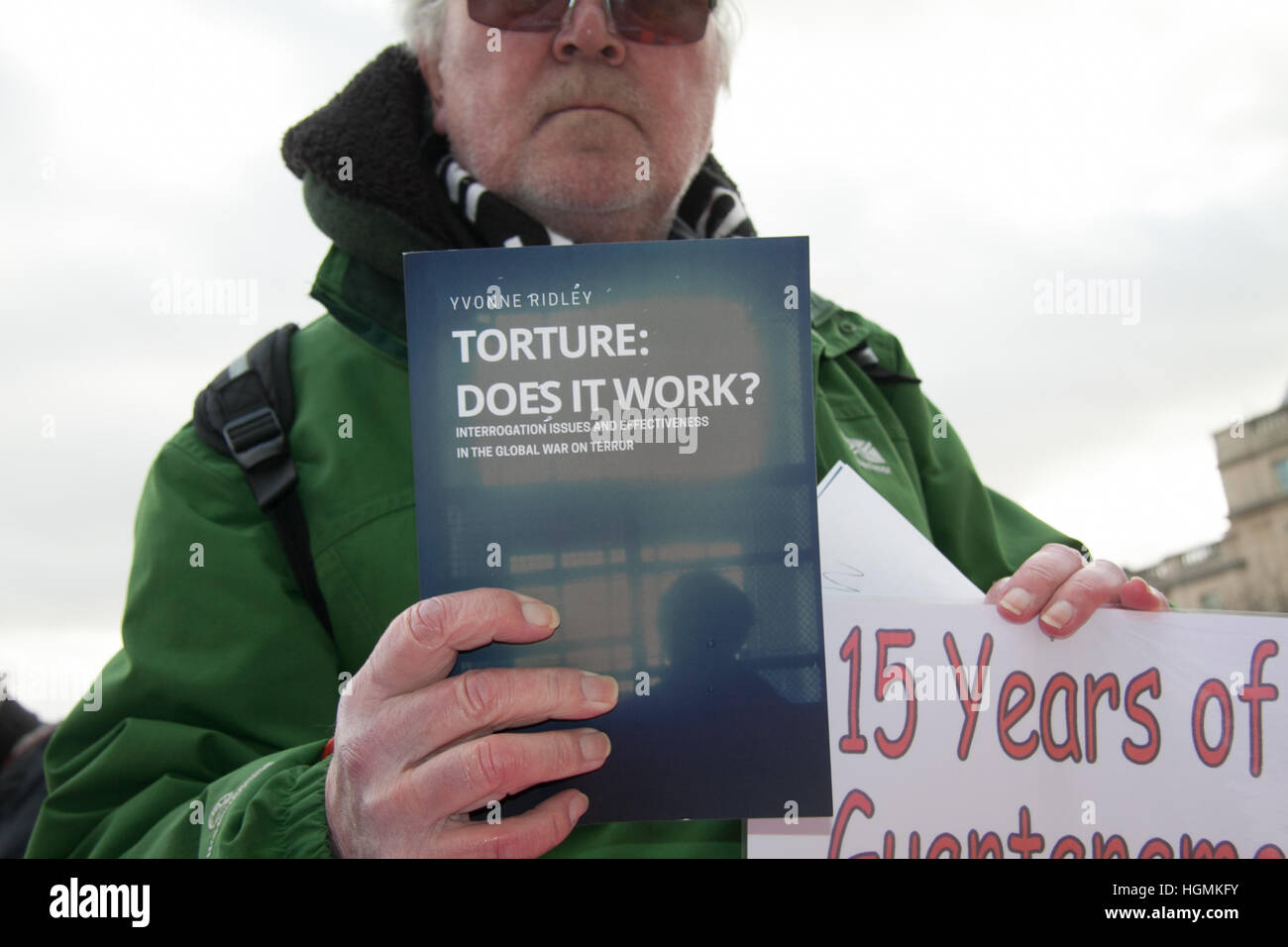 London UK. 11th January 2017. A protester holds a book which reads' Does Tourture Work' during a protest  against the US military camp in Guantanamo which turns 15 since it was opened in 11 January 2002 Credit: amer ghazzal/Alamy Live News Stock Photo