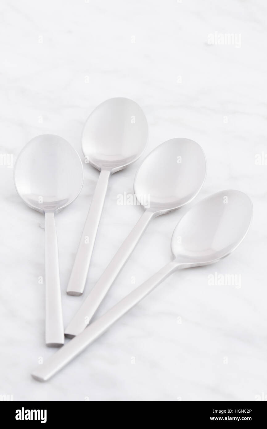 silver spoon set styled on antique carrara marble Stock Photo