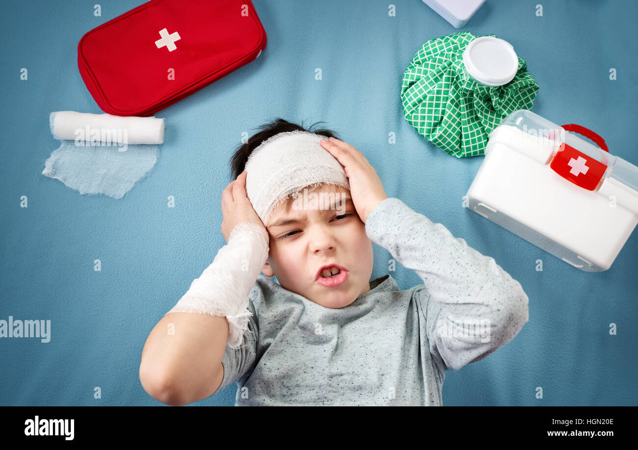 Child with bandages lying in bed Stock Photo Alamy