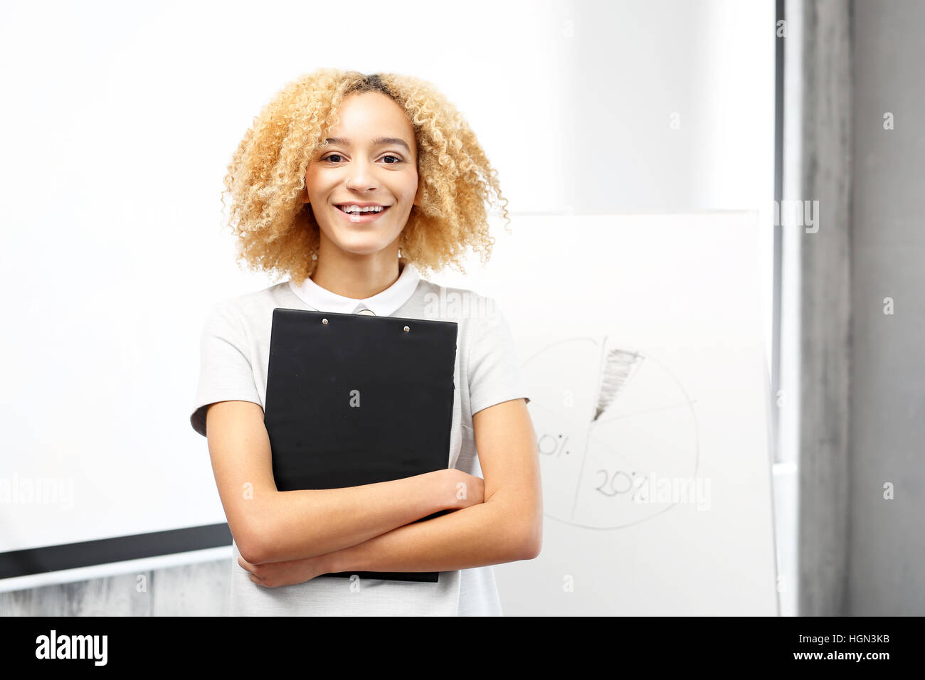 Public speech. A young woman during a business presentation in the conference room. Stock Photo