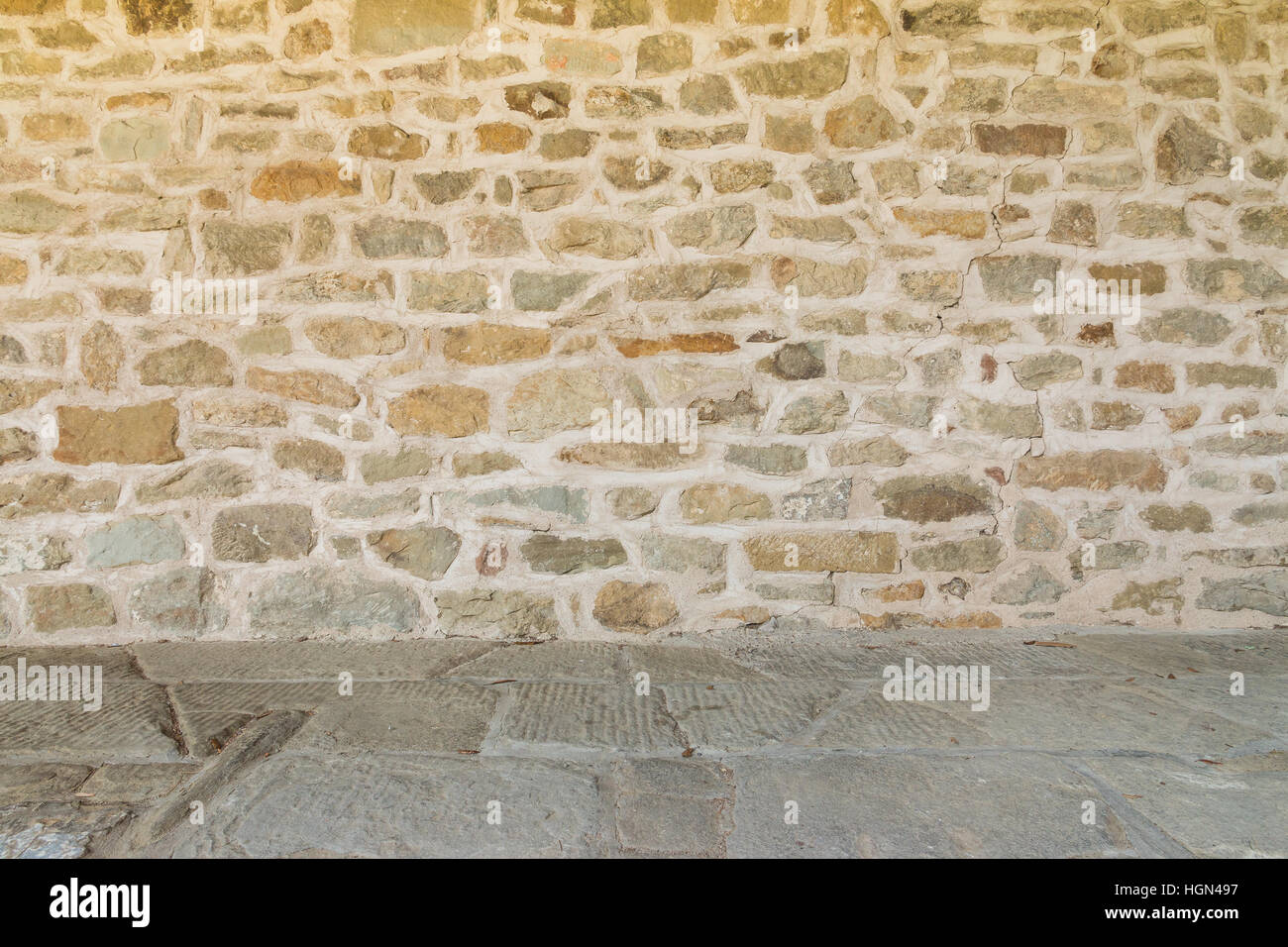 Rough medieval wall and floor of monastery Italy Stock Photo