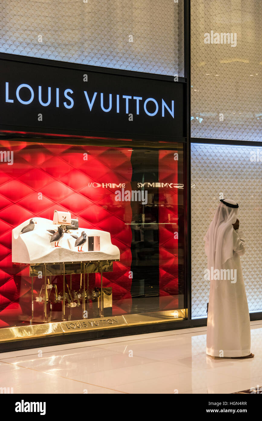 Traditionally dressed Middle Eastern man at Dubai Mall, Dubai, United Arab Emirates Stock Photo