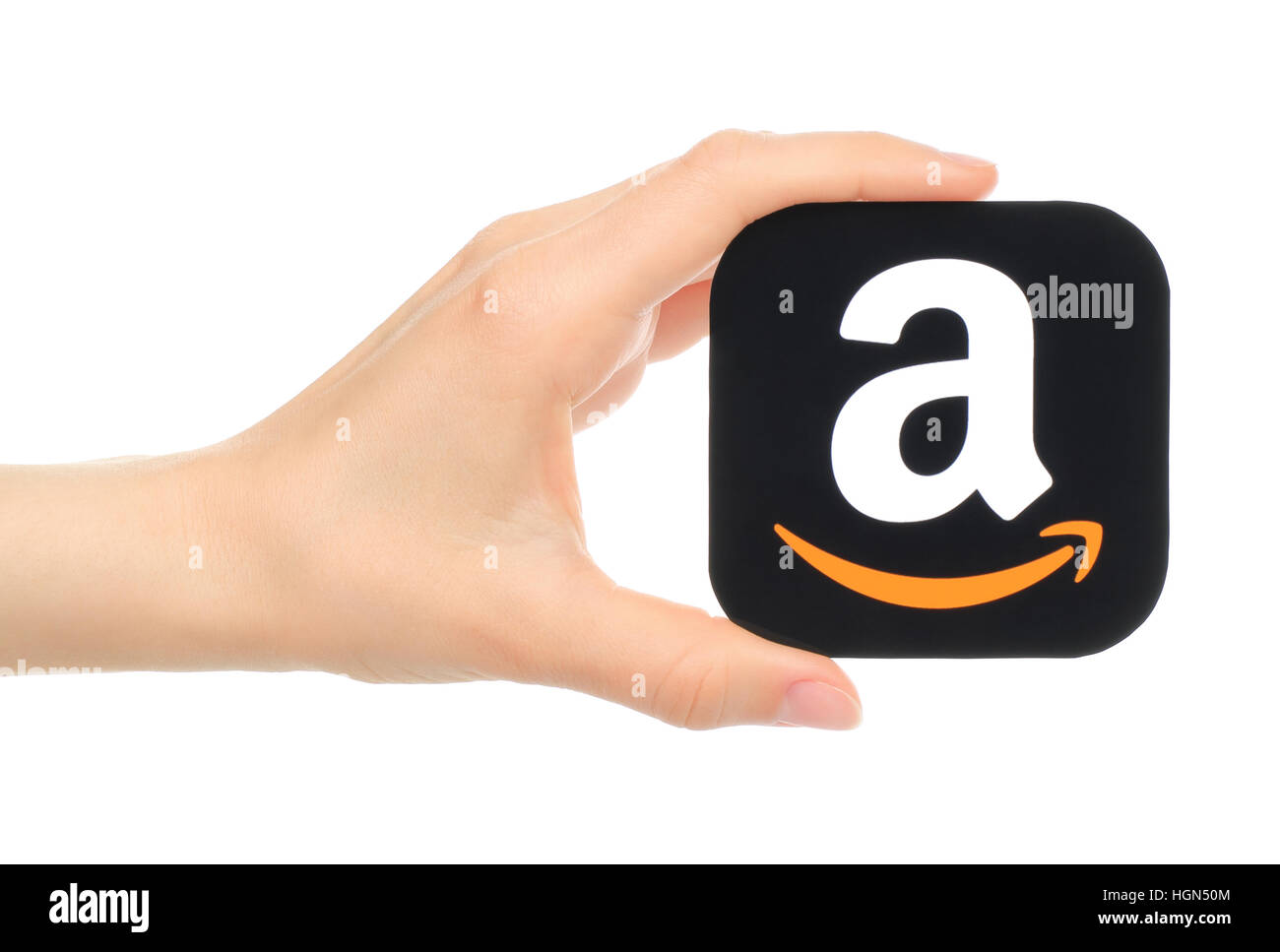 Kiev, Ukraine - May 18, 2016: Hand holds Amazon icon printed on paper. Amazon is an American electronic commerce company Stock Photo