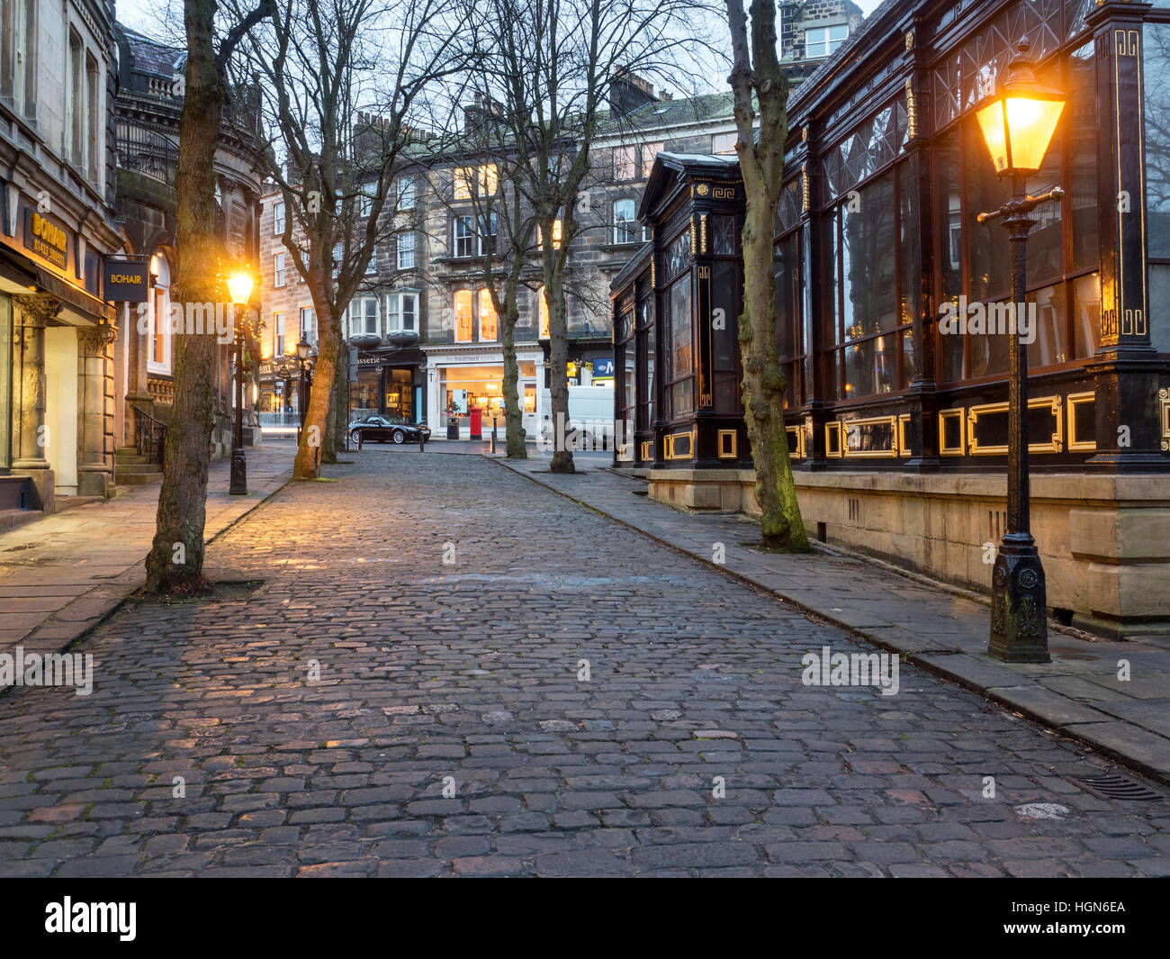 Crown Place Cobbled Street and Royal Pump Room Museum at Dusk Harrogate North Yorkshire England Stock Photo