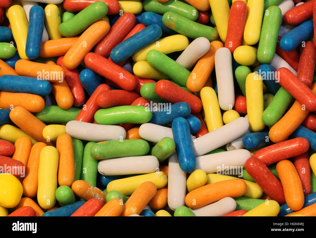 background of colorful confetti covered with colored sugar for sale in the candy store Stock Photo