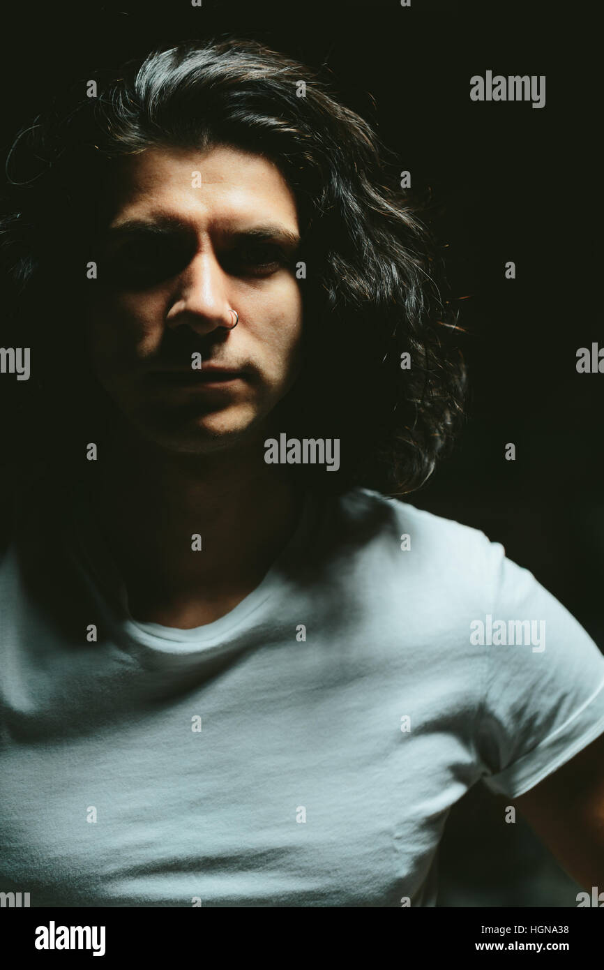 Portrait of a handsome young man with long hair Stock Photo - Alamy