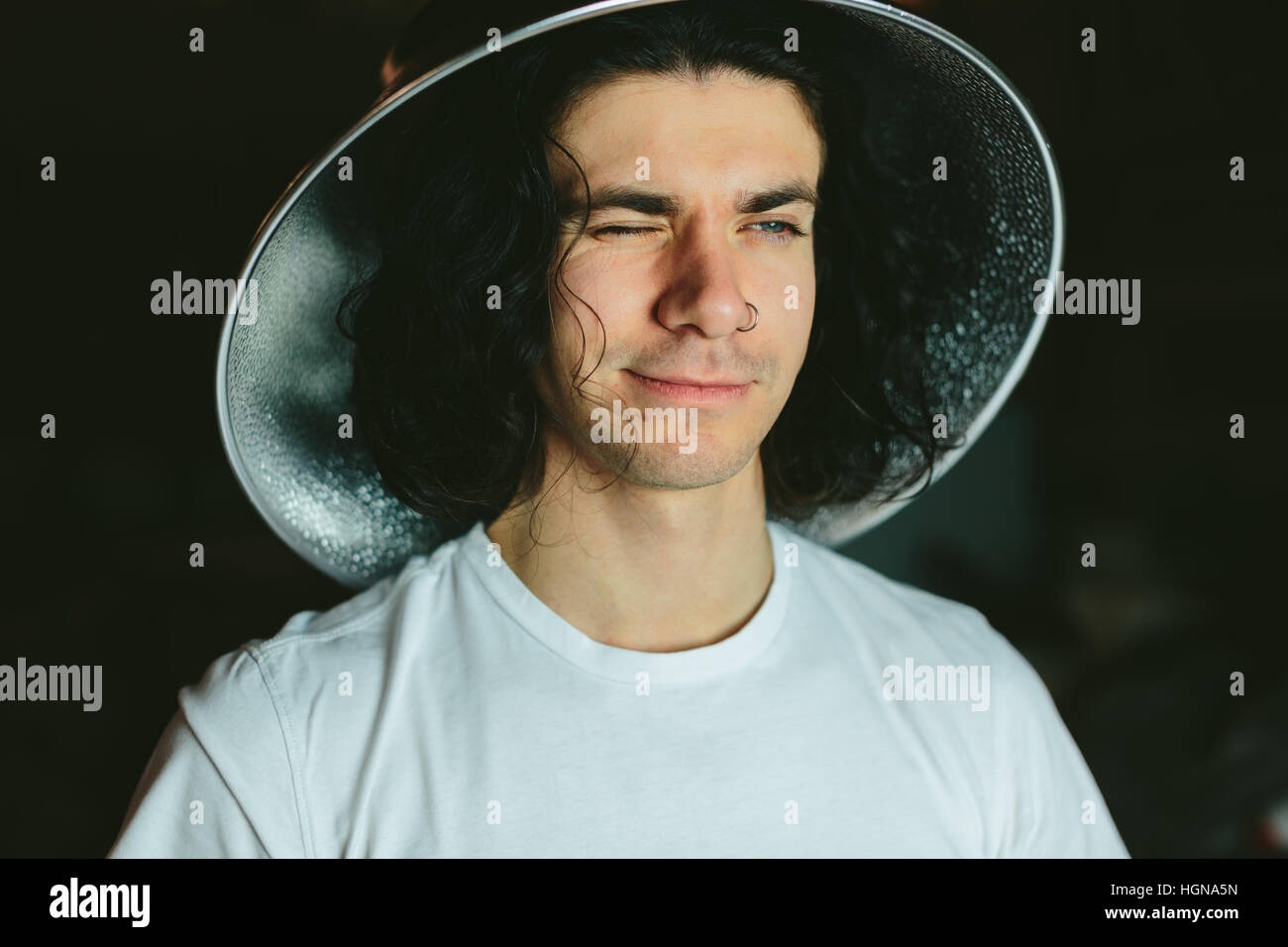 Portrait of a young man in  strange unusual hat Stock Photo