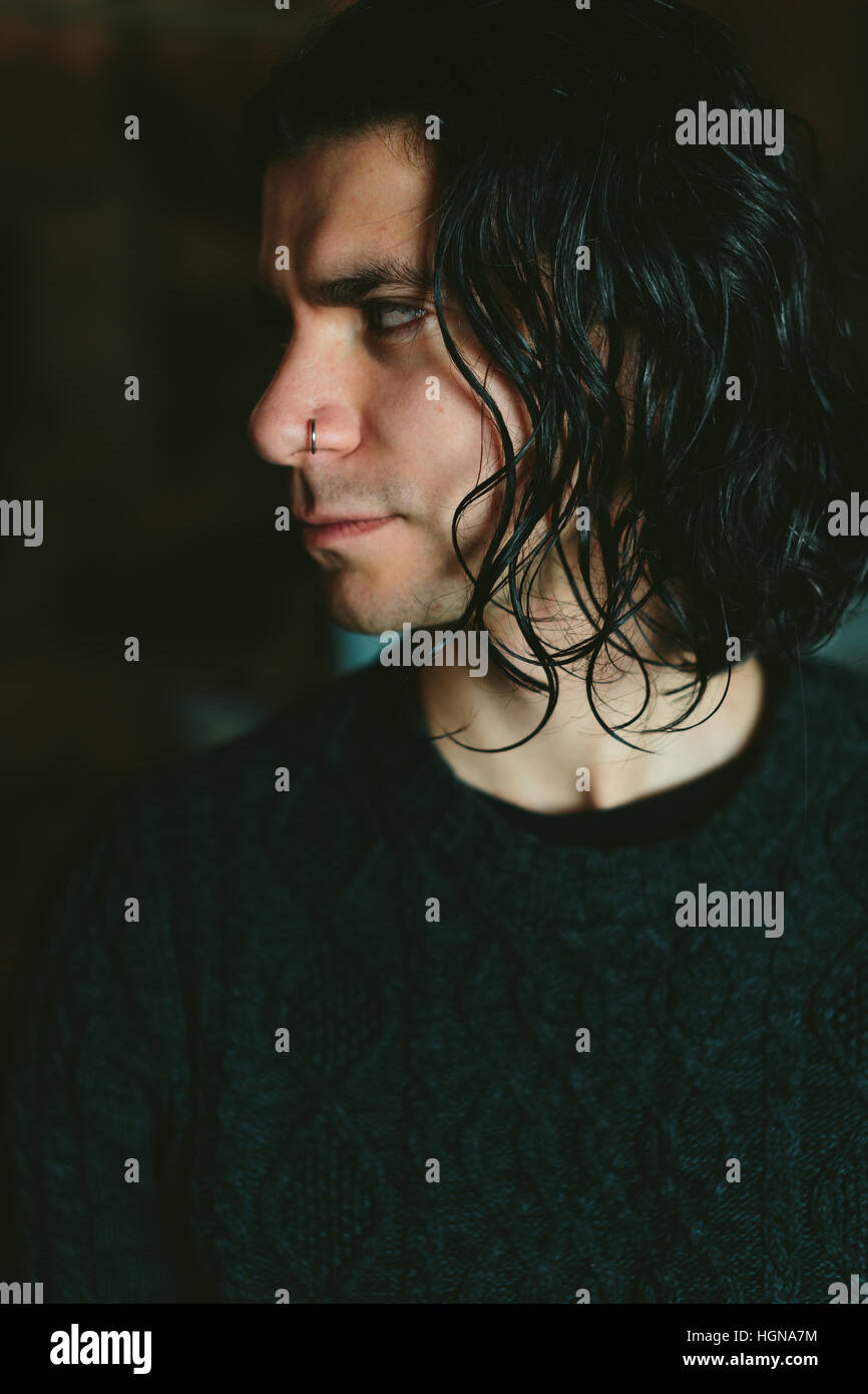 Portrait of the young long-haired brunette Man Stock Photo