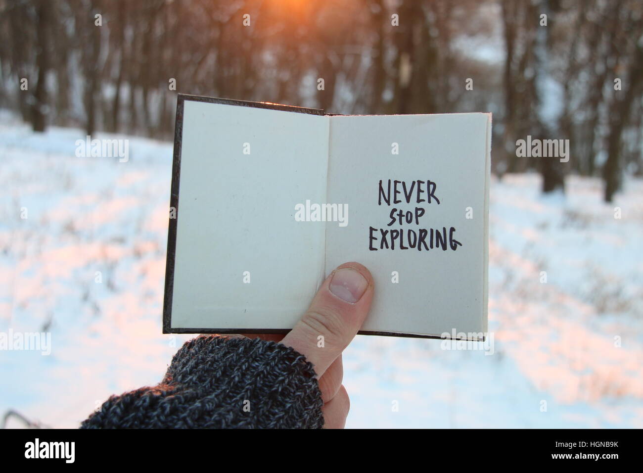 Never stop exploring. Inspirational and motivational quotes. . Book and text. Stock Photo