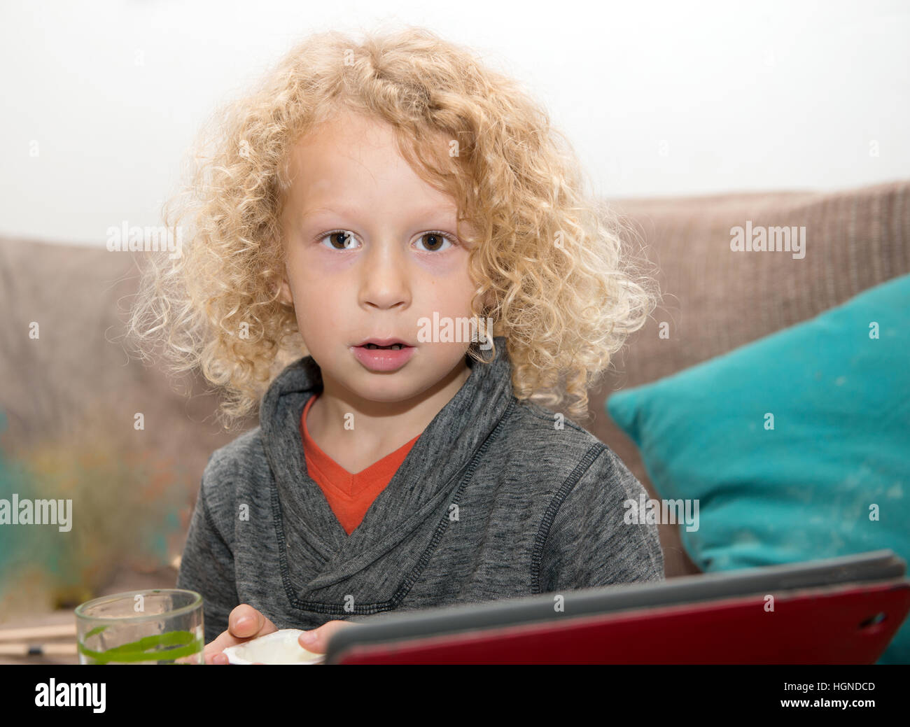 little blond boy using tablet computer at home Stock Photo - Alamy