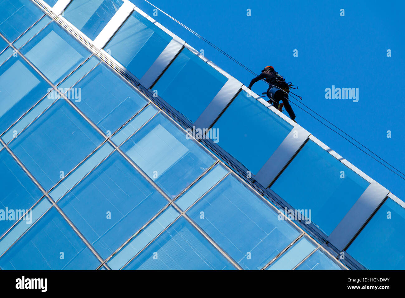 Window cleaning on a glass and steel office block in Vancouver, British Columbia, Canada. Stock Photo