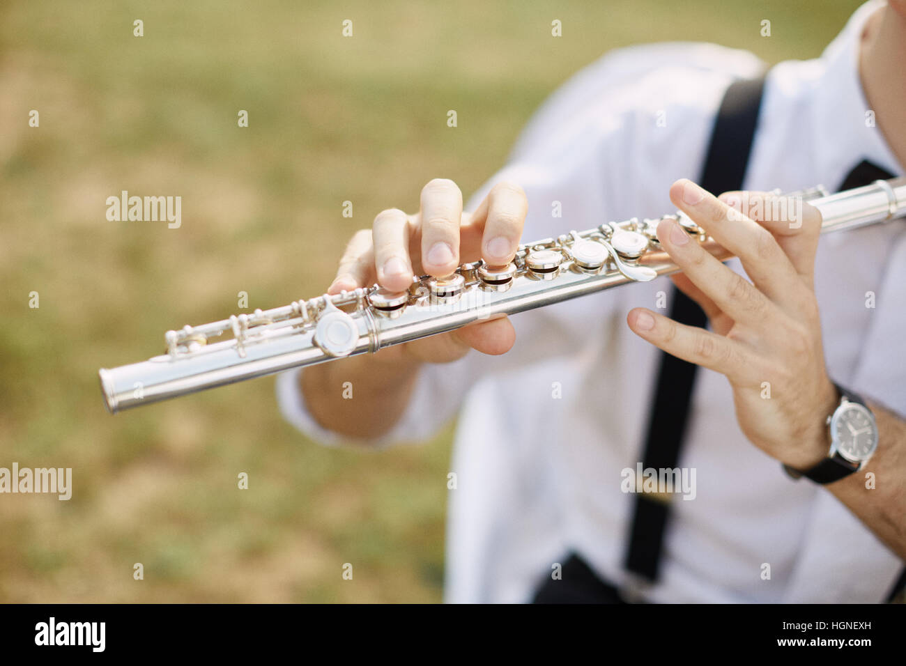 young man playing a clarinet or flute. flutist musician Stock Photo