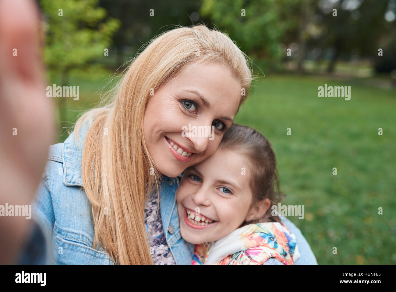 Mother and daugther taking a selfie outside Stock Photo